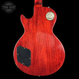 Red electric guitar body with Gibson logo on a black background