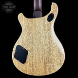 Back of a guitar with a 'Tone Shop' logo in the corner