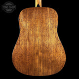 Close-up of a wooden acoustic guitar back with 'Tone Shop' logo.
