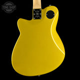 Yellow electric guitar on a black background with 'Tone Shop' logo.