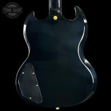 Back view of a black electric guitar with 'Tone Shop' logo.