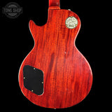 Back view of a red Gibson electric guitar on a black background with 'Tone Shop' logo.