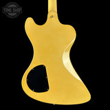 Gold electric guitar body on a black background with 'Tone Shop' logo.
