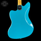 Blue electric guitar body with a visible brand logo on a black background