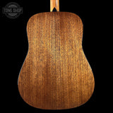 Back view of a wooden acoustic guitar with 'Tone Shop' logo in the corner.