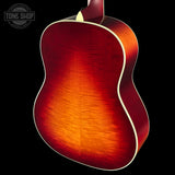 Close-up of a red acoustic guitar on a black background with 'Tone Shop' logo.