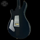 Black electric guitar with a visible brand logo on a black background