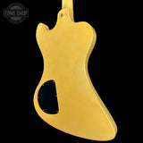 Gold electric guitar body on a black background with 'Tone Shop' logo.