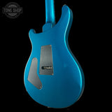 Blue electric guitar on a black background with 'Tone Shop' logo.