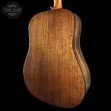 Close-up of a wooden acoustic guitar on a black background with 'Tone Shop' branding.