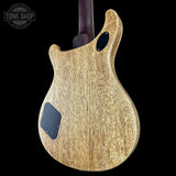 Back view of a wooden electric guitar with 'Tone Shop' branding.
