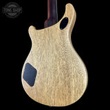 Wooden guitar body with a 'Tone Shop' logo in the corner