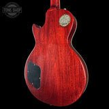 Red electric guitar body with Gibson logo on a black background