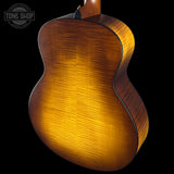 Close-up of a wooden acoustic guitar on a black background with 'Tone Shop' logo.