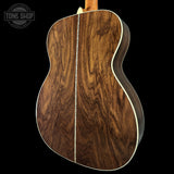 Wooden guitar body with a visible brand logo in the corner