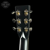 Close-up of a guitar headstock with tuning pegs on a black background, featuring 'Tone Shop' branding.