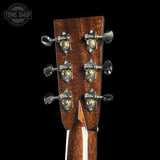 Close-up of a guitar headstock with tuning pegs on a black background, featuring the Tone Shop logo.
