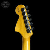 Guitar headstock with tuning pegs on a black background, featuring the Tone Shop logo.