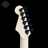 Guitar headstock with tuning pegs on a black background, featuring the Tone Shop logo.