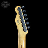Guitar headstock with tuning pegs on a black background, featuring the Tone Shop logo.