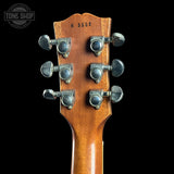 Guitar headstock with tuning pegs on a black background, featuring 'Tone Shop' logo.
