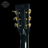 Close-up of a guitar headstock with tuning pegs on a black background, featuring the Tone Shop logo.