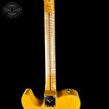 Close-up of a yellow electric guitar's neck and body on a black background with 'Tone Shop' logo.