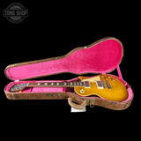 Gibson Les Paul guitar in a pink-lined case with 'Tone Shop' logo.