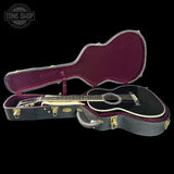 Acoustic guitar in a case with 'Tone Shop' logo in the corner