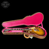 Gibson Les Paul guitar in a pink case with 'Tone Shop' logo.