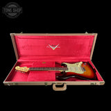 Fender guitar in a red-lined case with Fender logo, Tone Shop branding.