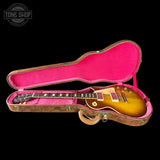 Gibson Les Paul guitar in a pink case with 'Tone Shop' logo.