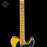 Yellow electric guitar with a black background