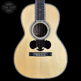 Acoustic guitar with a visible brand logo in the corner