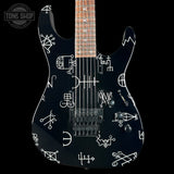 Black electric guitar with white geometric patterns on a black background, featuring 'Tone Shop' logo.