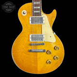 Electric guitar with a sunburst finish on a black background, featuring the Tone Shop logo.