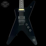Black electric guitar with a unique body shape on a black background, featuring the 'Tone Shop' logo.