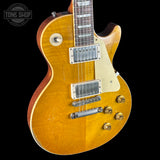 Electric guitar with a sunburst finish on a black background, featuring the Tone Shop logo.