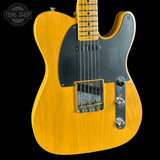 Electric guitar with a blonde finish and black pickguard on a black background, featuring the Tone Shop logo.