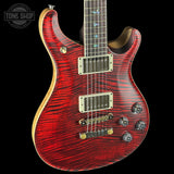 Red electric guitar with a black background