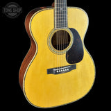 Acoustic guitar with a visible brand logo in the corner