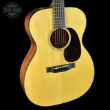 Acoustic guitar with a visible brand logo on a black background