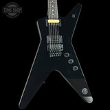 Black electric guitar with a unique body shape on a black background, featuring the 'Tone Shop' logo.