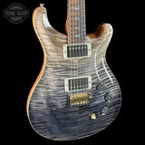 Electric guitar with a wavy wood finish on a black background, featuring the Tone Shop logo.