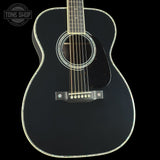 Black acoustic guitar on a black background with 'Tone Shop' logo.