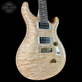 Front angle of PRS Wood Library Custom 24 Quilt 10 Top Natural.