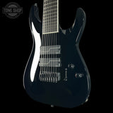 Black electric guitar on a transparent background with 'Tone Shop' logo.
