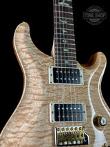 Front angle of PRS Wood Library Custom 24 Quilt 10 Top Natural.