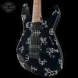 Black electric guitar with white patterns on a black background, featuring 'Tone Shop' logo.