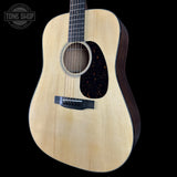 Acoustic guitar with a visible brand logo on a black background